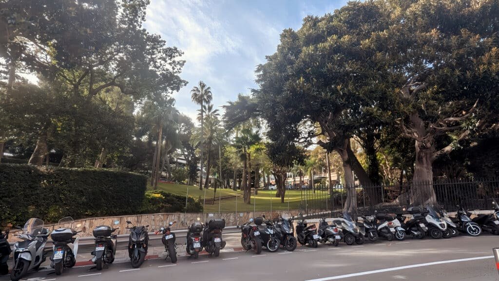 Avenue Princess Grace and Japanese Gardens with mopends and motorbikes lined up infront of the gardens