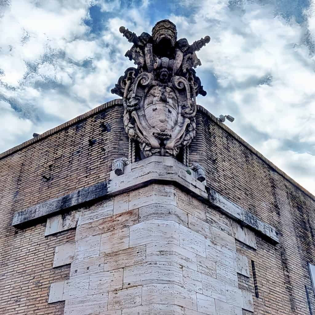 Papal coat of arms on side of Vatican wall
