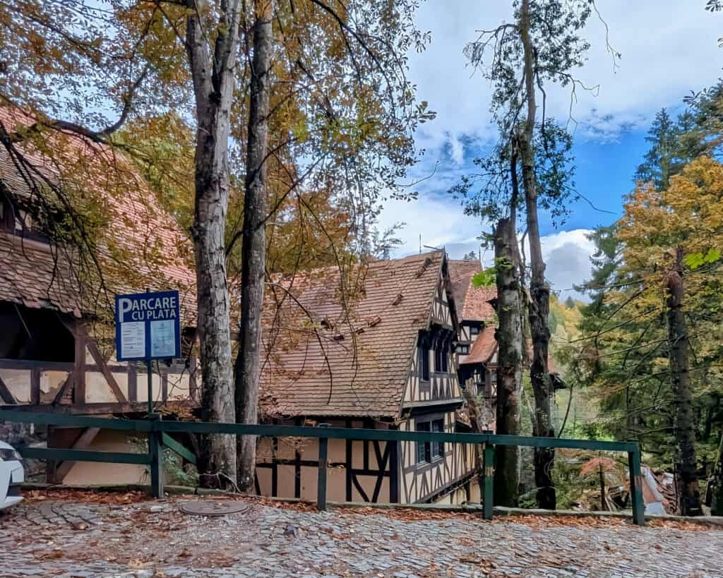 Peles Castle - The Grounds - wooded mountain setting with timbered buildings
