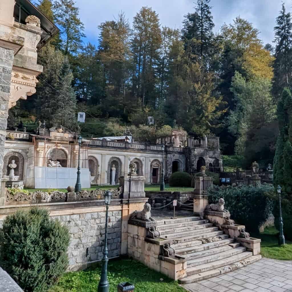 Peles Grounds castle - steps at the side and row of statues and busts