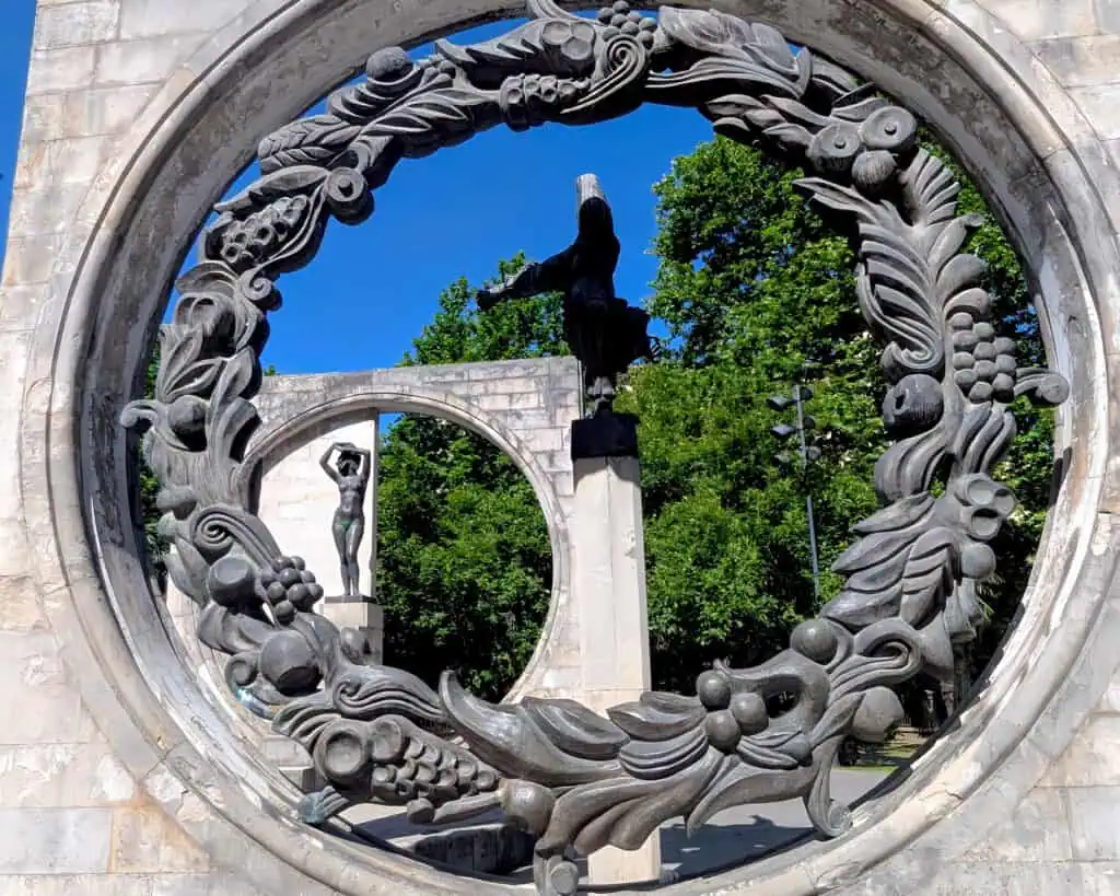 monument at Kutaisi's Soviet Sculpture Complex. A series of rectangular blocks with circles, carvings and figures