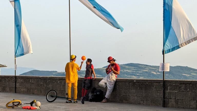 san marino performers looking over the city walls at the mountainous view