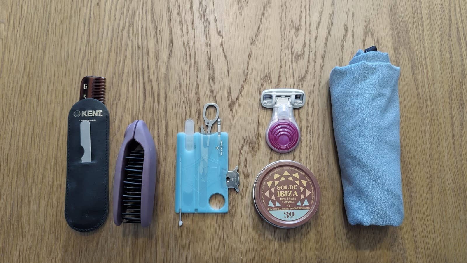 Other Personal Care Items - One Bag Packing - Travel Toiletries - comb and nail file set - folding hairbrush - swisscard nailcare multitool - sol de Ibiza spf - Matador nanodry towel - large rolled up