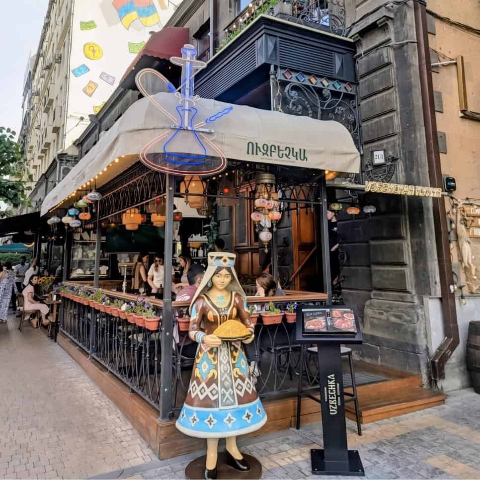 Uzbechka restaurant located on Tumanyan Street in Yerevan - traditional doll outside with menu