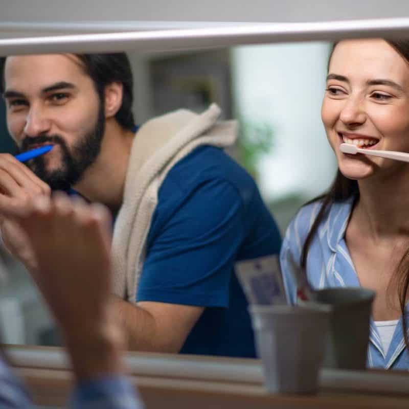 Smiling woman brushing teeth during dental checkup at Oroville Gentle Dentistry.