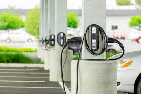 Row of electric vehicle charging stations at an outdoor parking area.