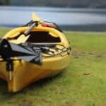 Yellow kayak on grassy lakeshore