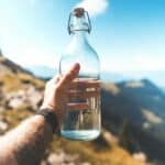 a glass water bottle on a hike