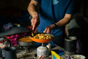 someone cooking while camping