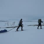 someone pulling a sled in the winter