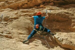 a woman climbing rocks