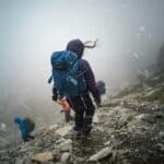 walking down mountain in blizzard