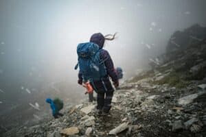 walking down mountain in blizzard