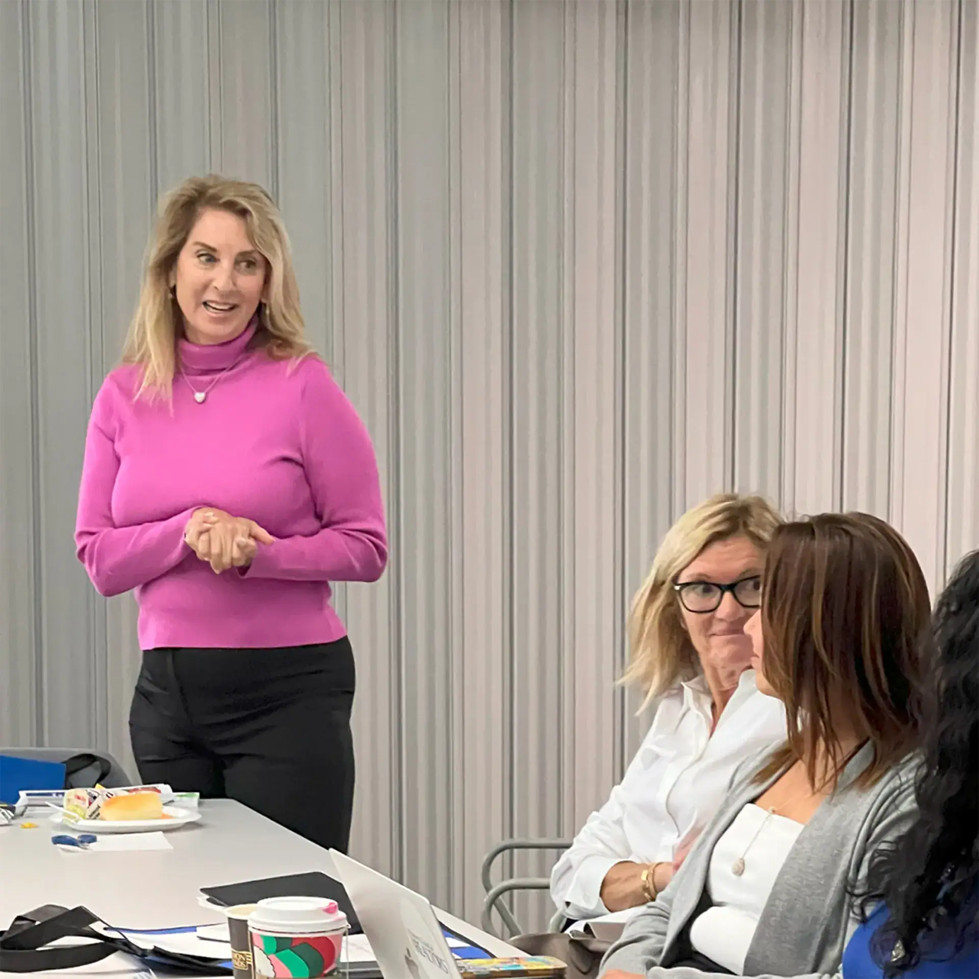 Women engaged in a discussion during a business meeting.