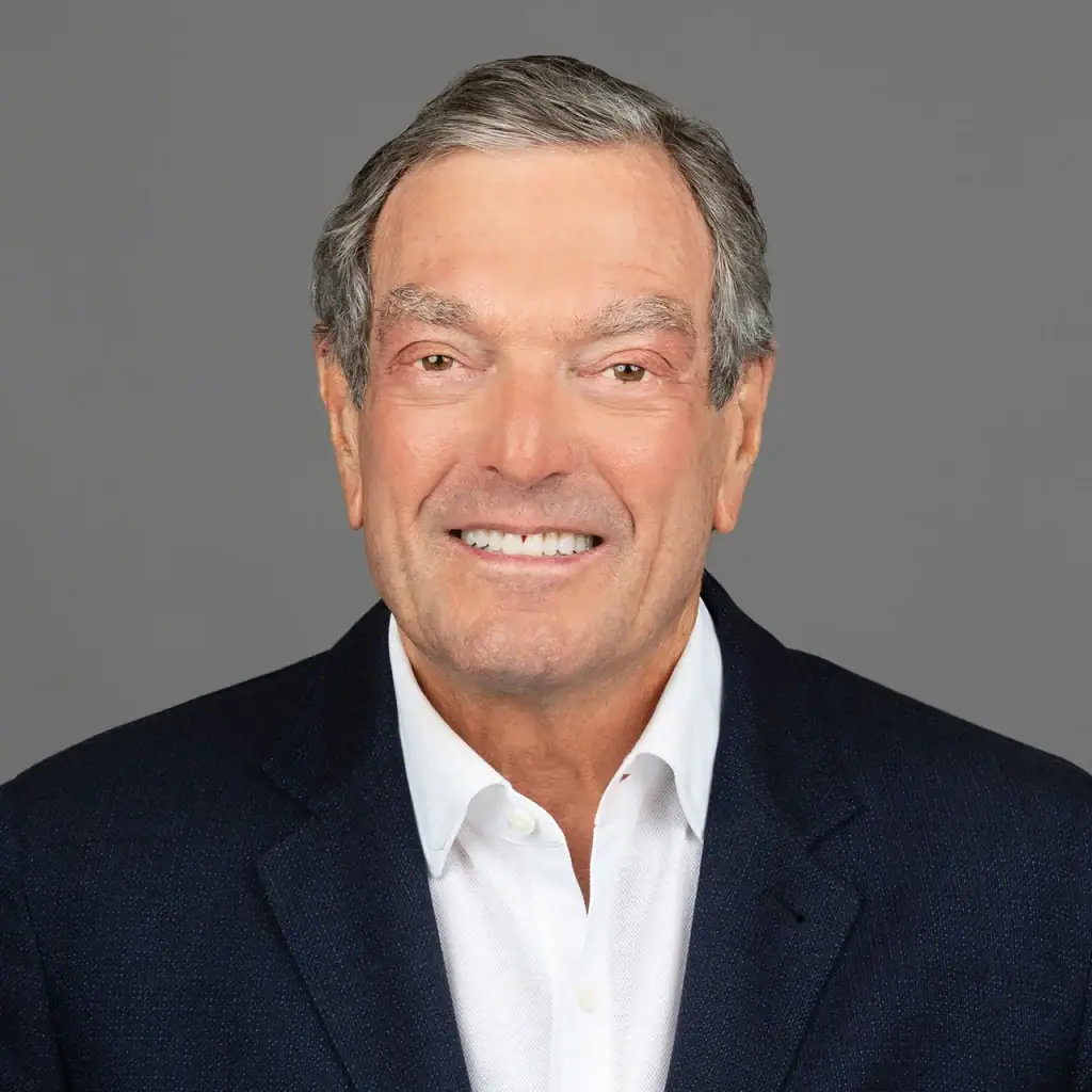 Smiling man in a suit, representing Palm Beach Police and Fire Foundation.
