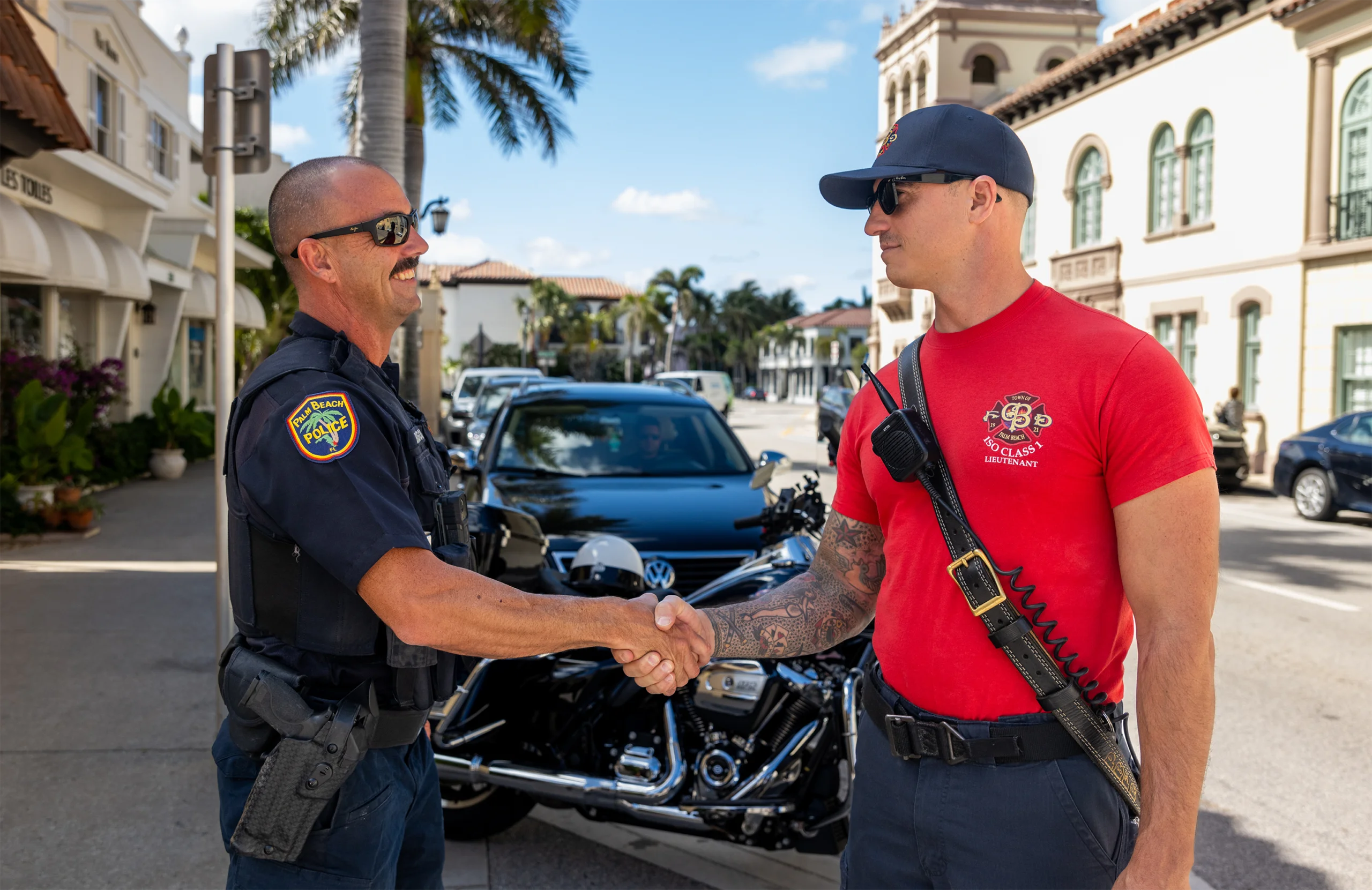 Police officer and firefighter shaking hands.