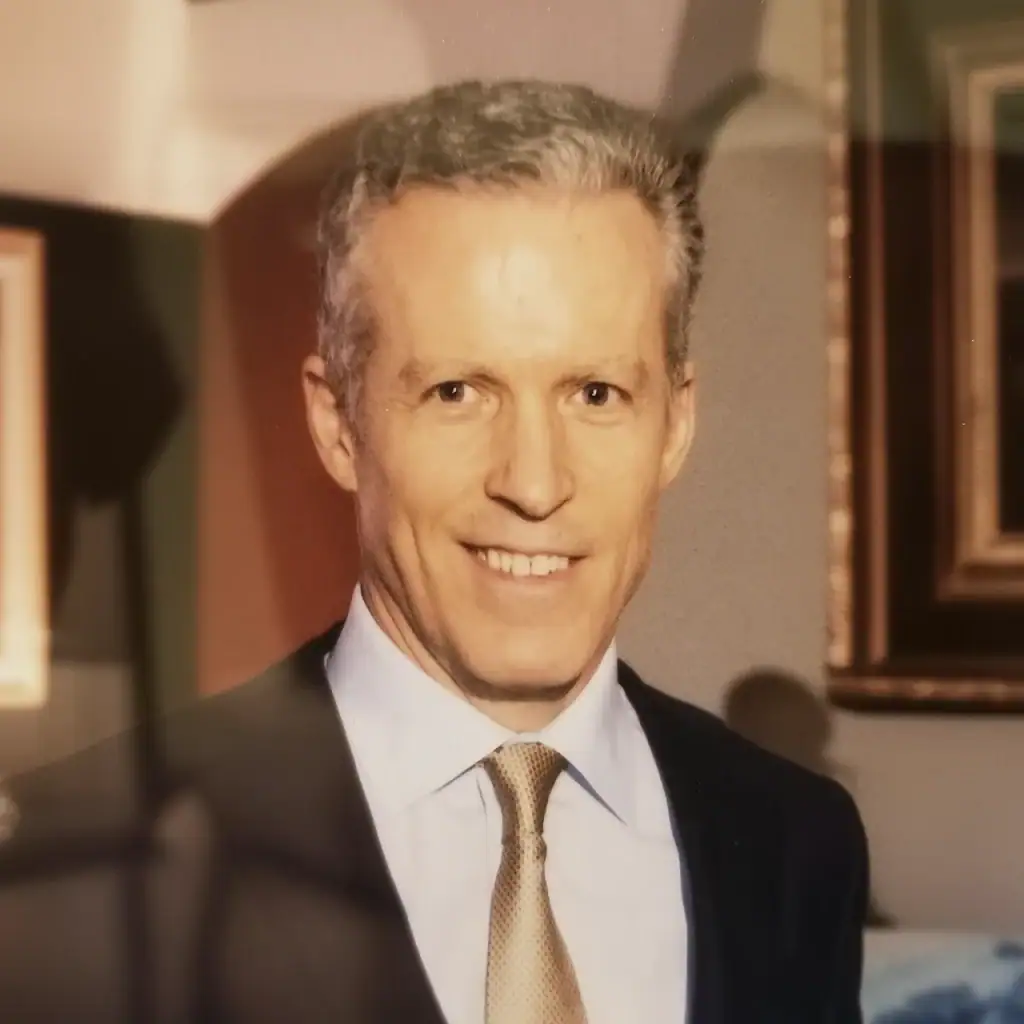 Portrait of a smiling man in formal attire at Palm Beach Police and Fire Foundation event.
