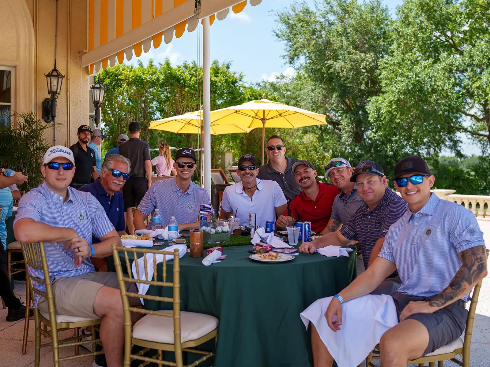 Group of people enjoying outdoor dining at Palm Beach Police and Fire Foundation event.