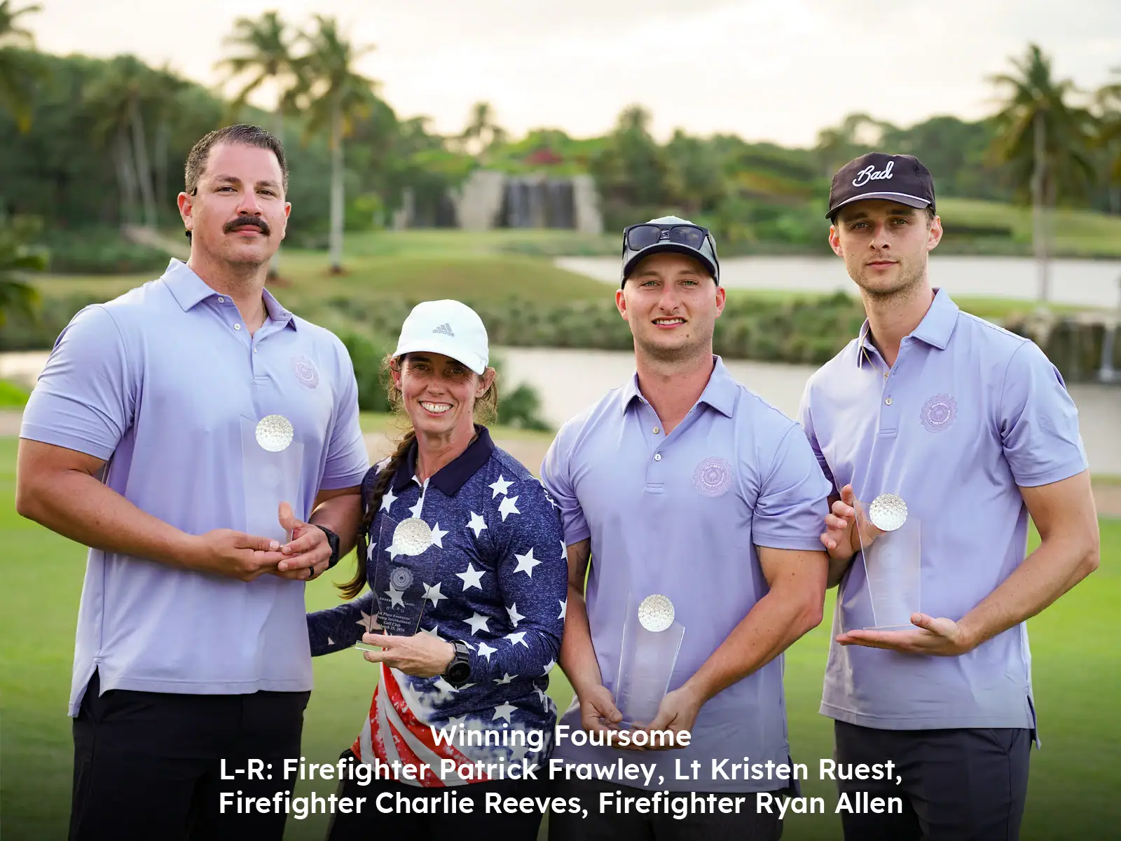 Four people holding awards on a golf course, celebrating victory at Palm Beach event.