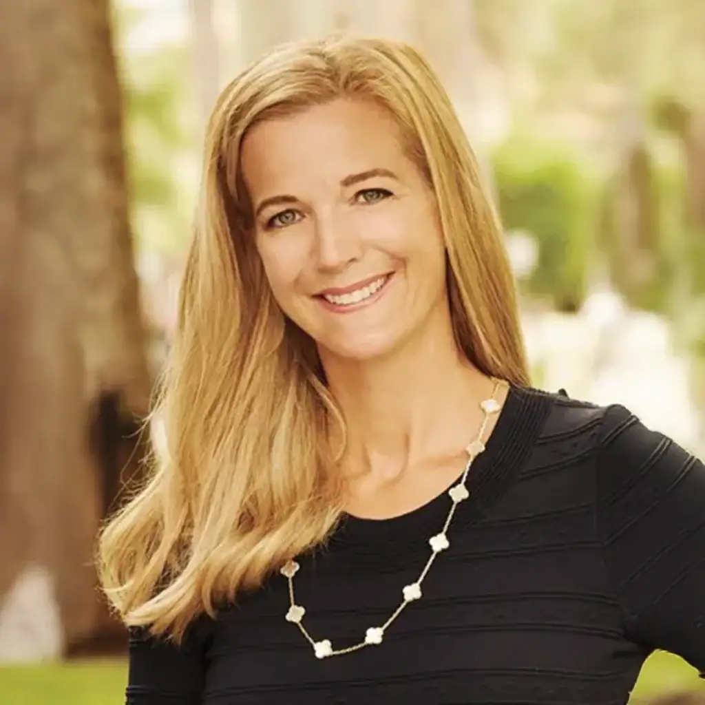 Smiling woman with long blonde hair outdoors, representing Palm Beach Police and Fire Foundation.