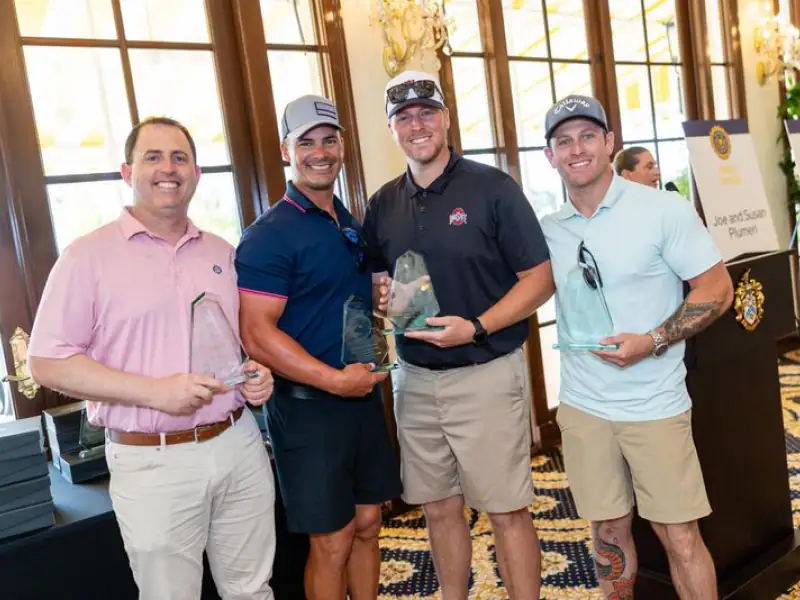 Group of men holding awards at Palm Beach Police and Fire Foundation event.