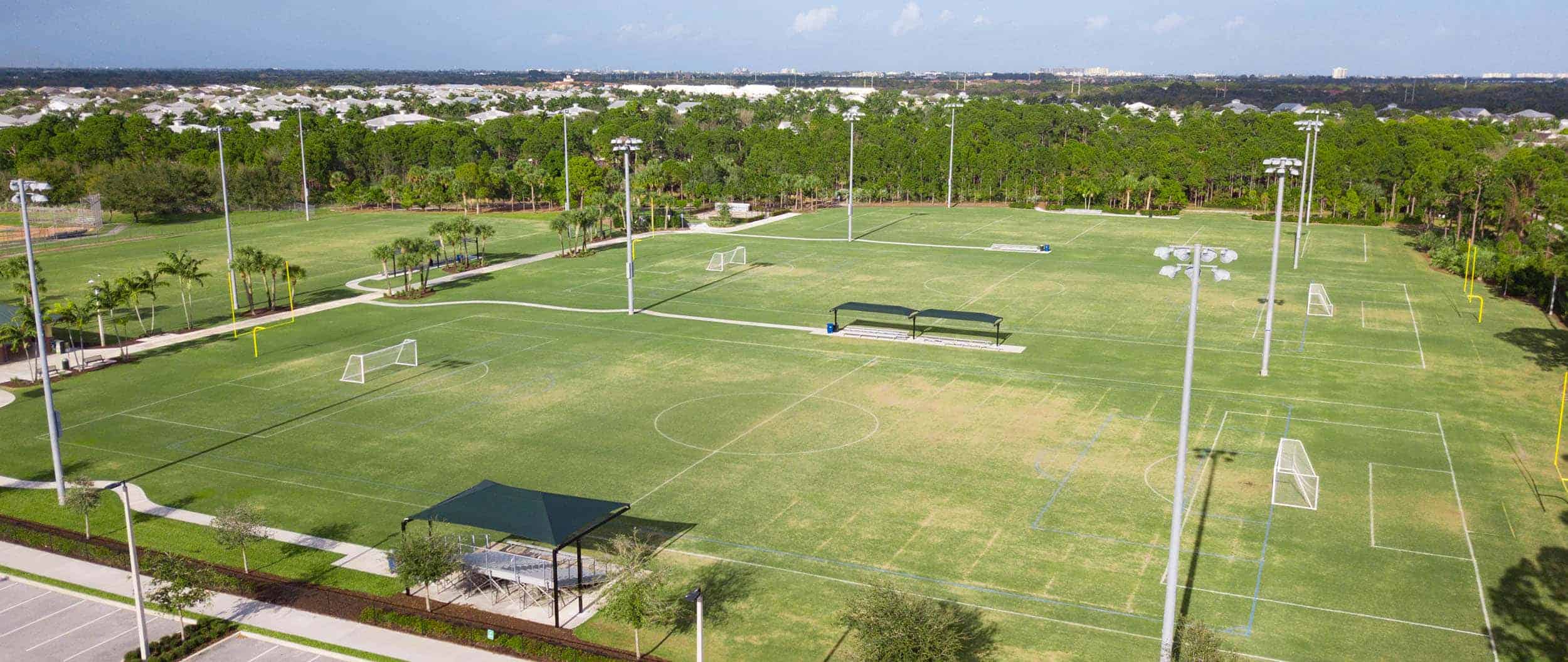 Aerial view of Abacoa Community Park sports fields with soccer goals and lighting.