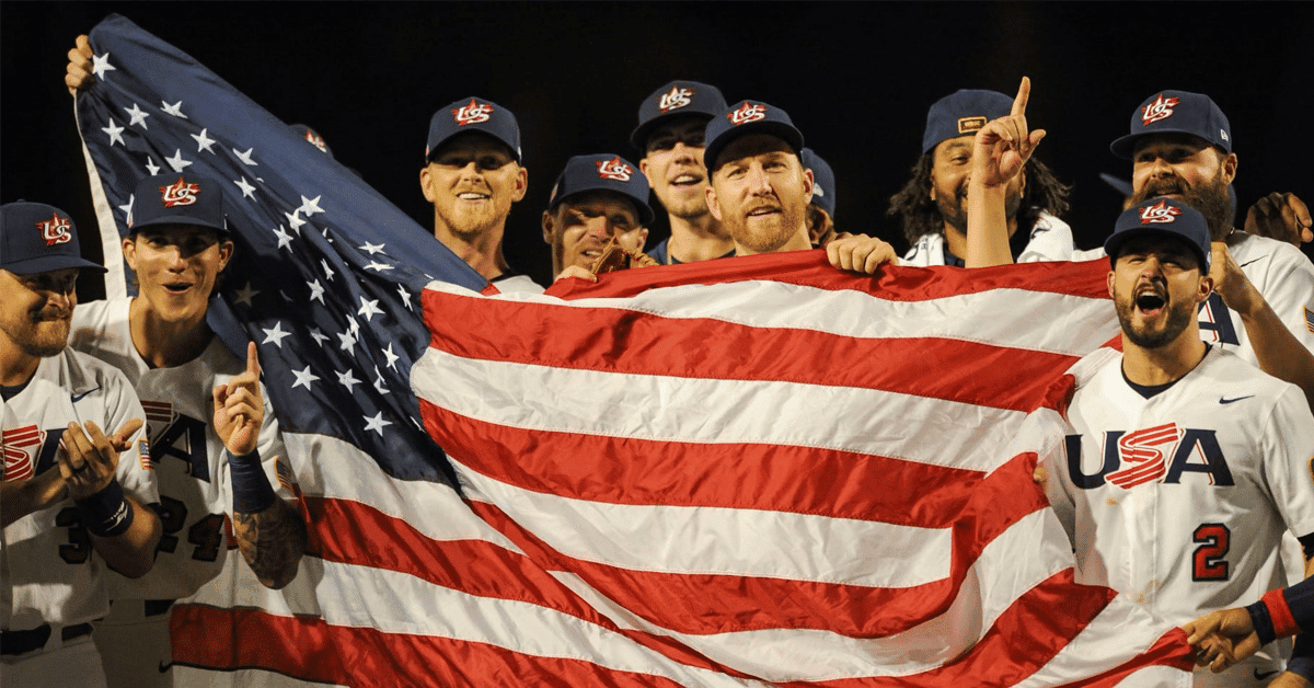 Team USA baseball team celebrating with American flag after winning silver in Tokyo.