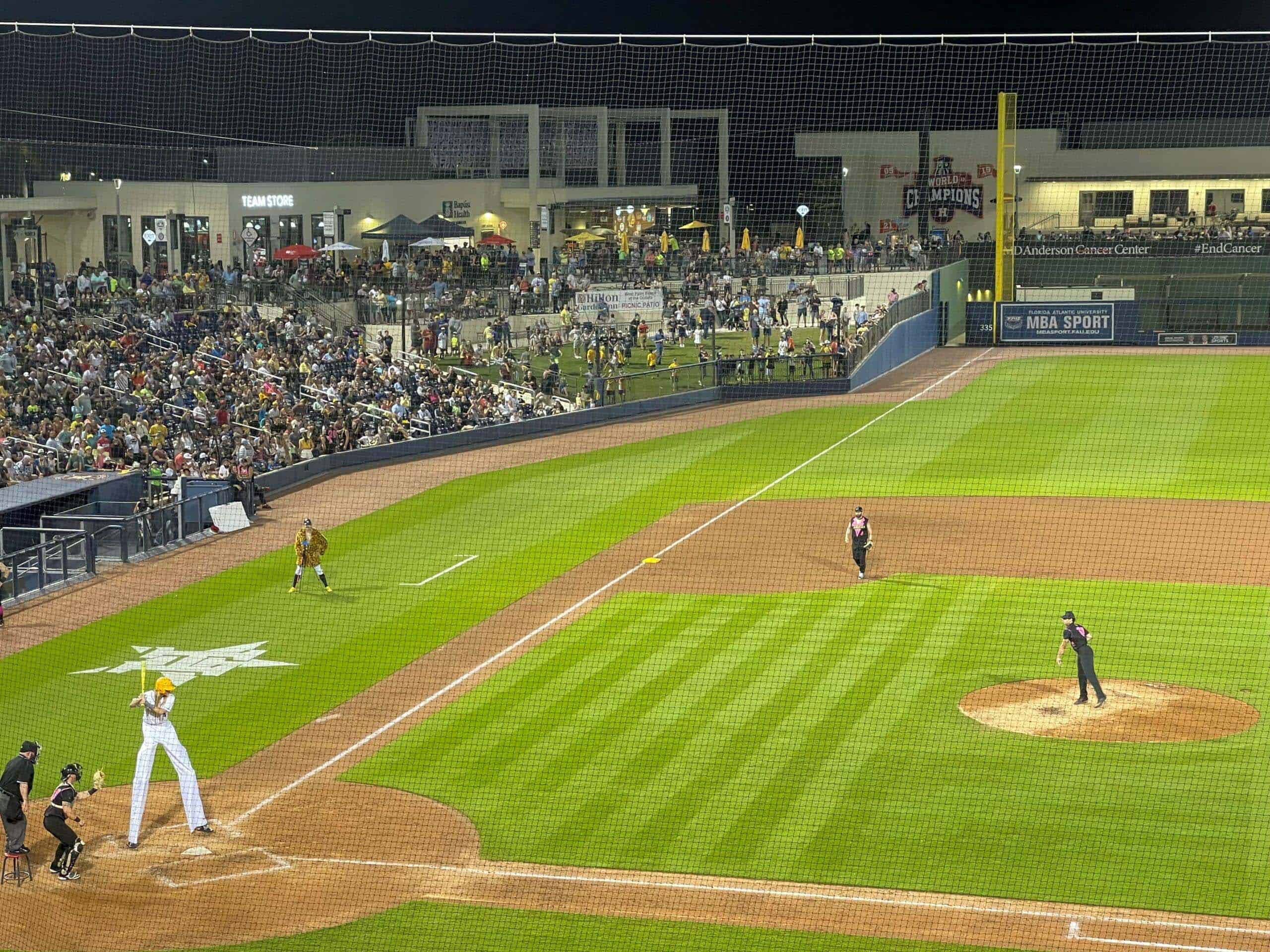 Exciting baseball game at Palm Beach County Sports complex with crowd and players.