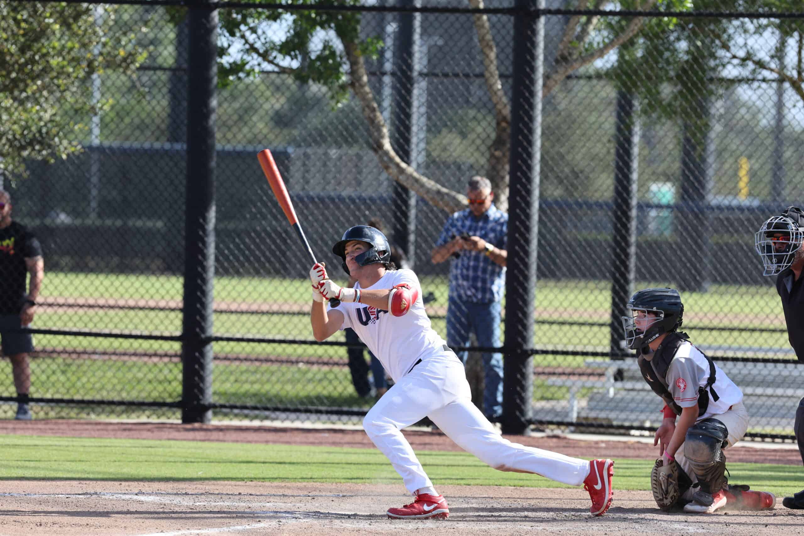 Youth baseball player swinging bat at Palm Beach sports complex.