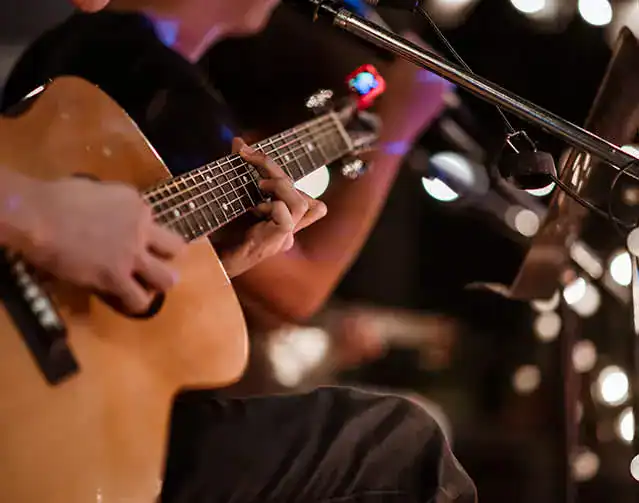 Guitarist playing live music at an event on Partybody.