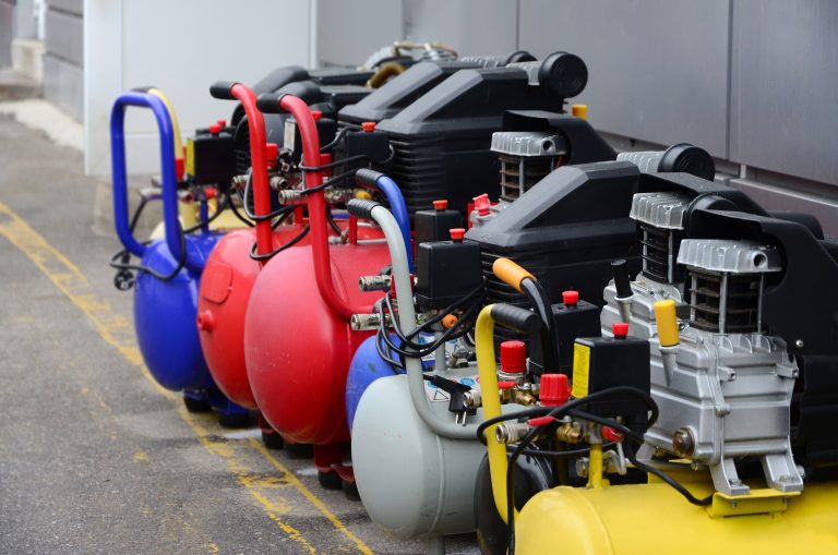 Row of colorful air compressors with tanks and motors