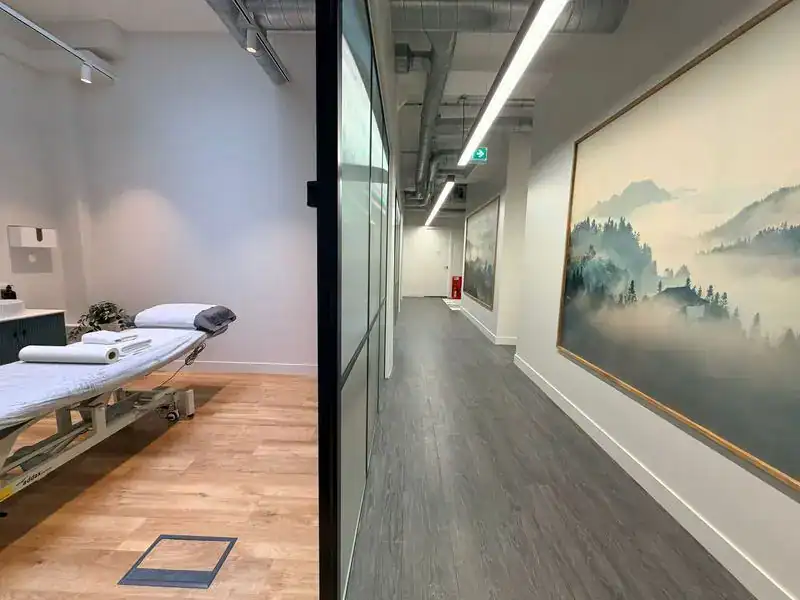 Modern physiotherapy clinic corridor with calming artwork at Physio-medicine London.