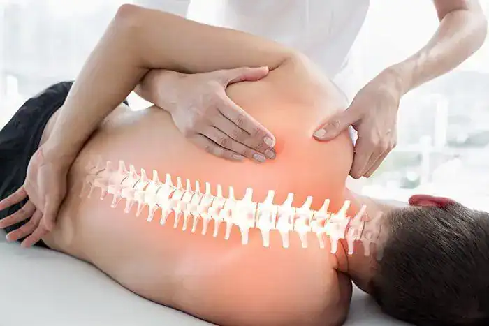 Physiotherapist providing back pain therapy to a patient in London clinic.