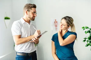 Physio-medicine London Consultation Physio-medicine London physiotherapist assessing patient with neck pain.