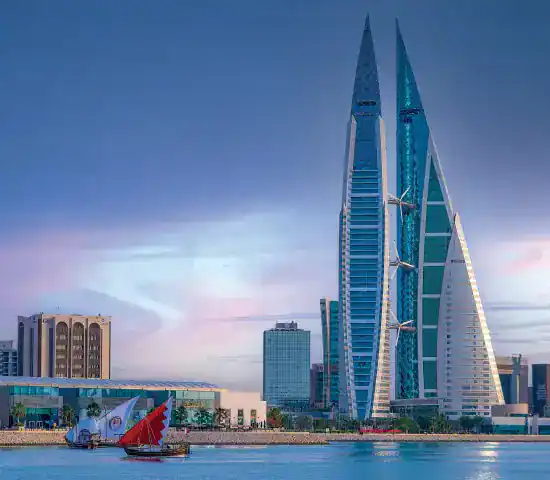 Bahrain World Trade Centre and Manama skyline at dusk — company formation and business setup in Bahrain by PI Startup Advisory