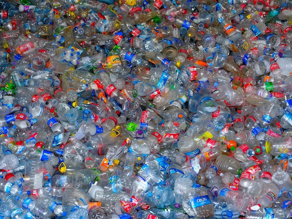 Colorful heap of discarded plastic bottles highlighting recycling and waste management.
