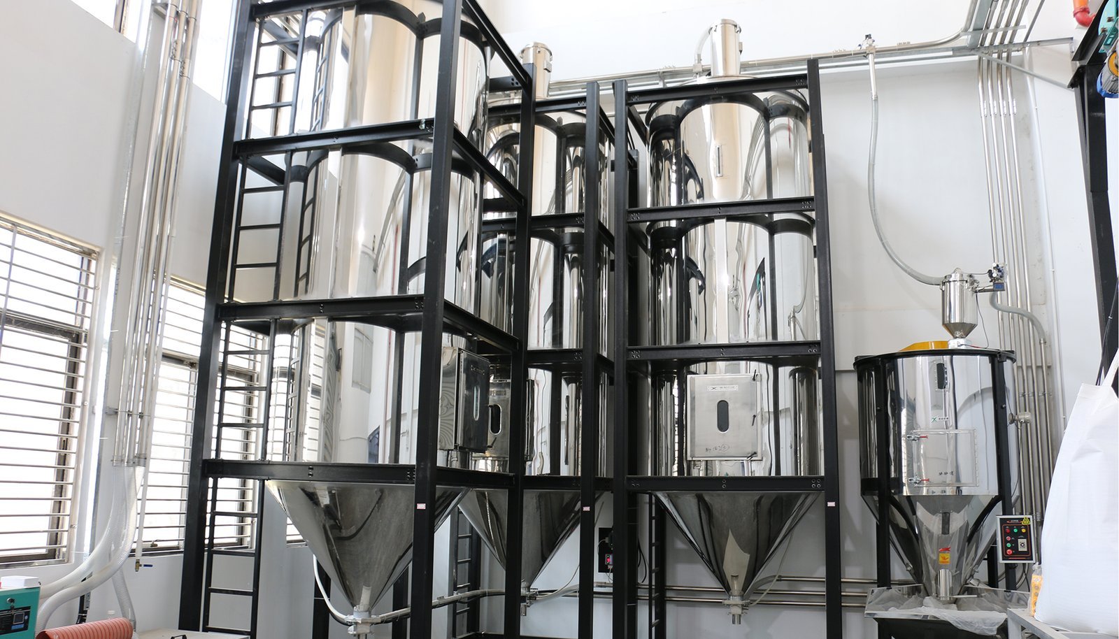 High-capacity plastic and glass container manufacturing equipment in a production facility.