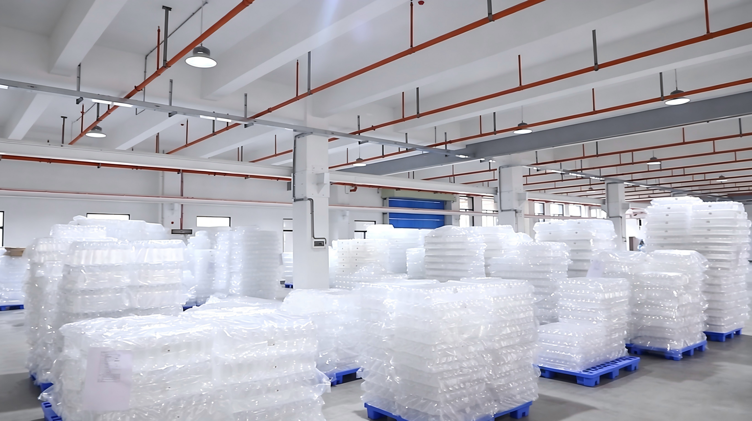 Wholesale plastic containers and bottles in a modern manufacturing facility.