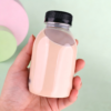 Recyclable 8 oz BPA-free round juice bottle with black cap.