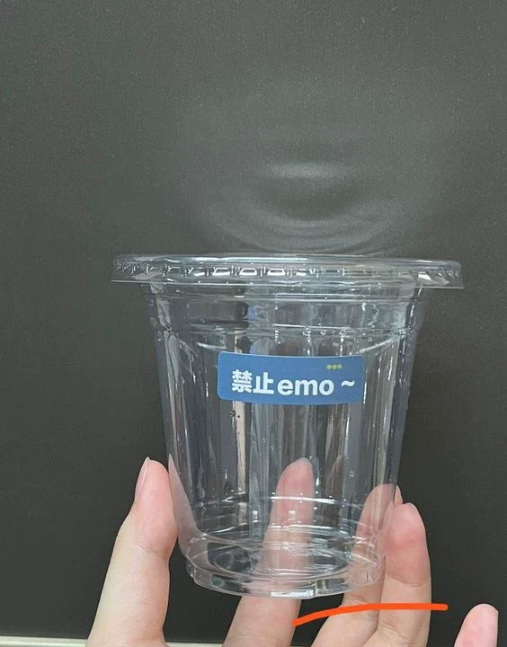 PET cold cups filled with drinks are placed on the bar counter. PET cups are suitable for juice shops, coffee shops, soft drink shops, and bubble tea shops.