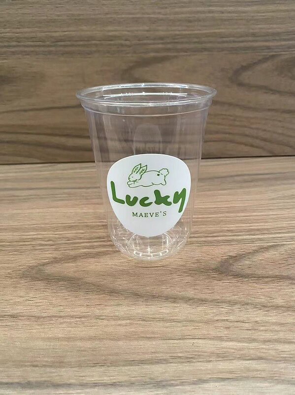 Transparent plastic cup with "Lucky" logo and rabbit illustration for branding.
