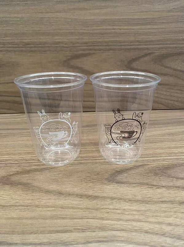 Transparent plastic cups featuring adorable bunny illustrations, ideal for beverages and party use.