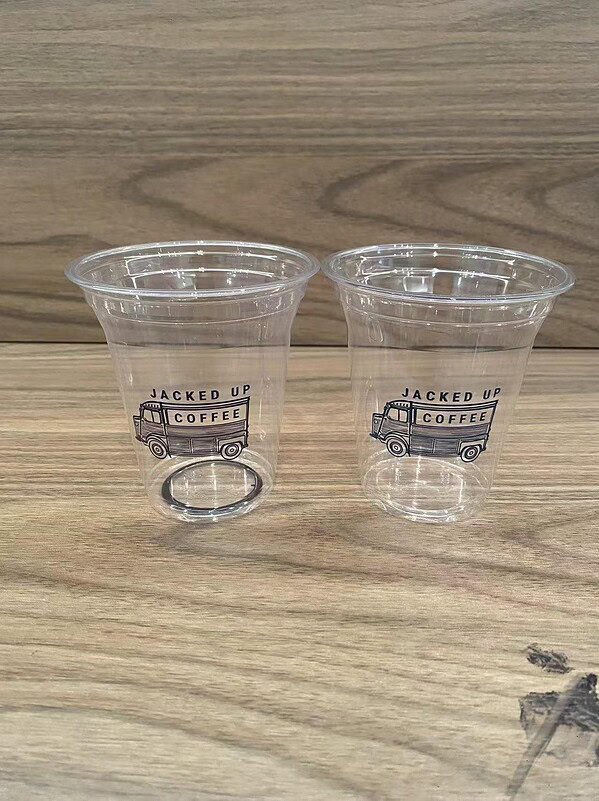 Reusable clear plastic cups for coffee with printed "Jacked Up Coffee" logo. Perfect for cafes, even.