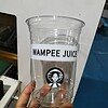 Clear plastic juice cup with label and logo.