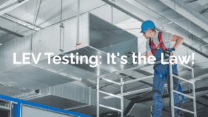 Worker performing LEV testing in industrial setting for air quality compliance.