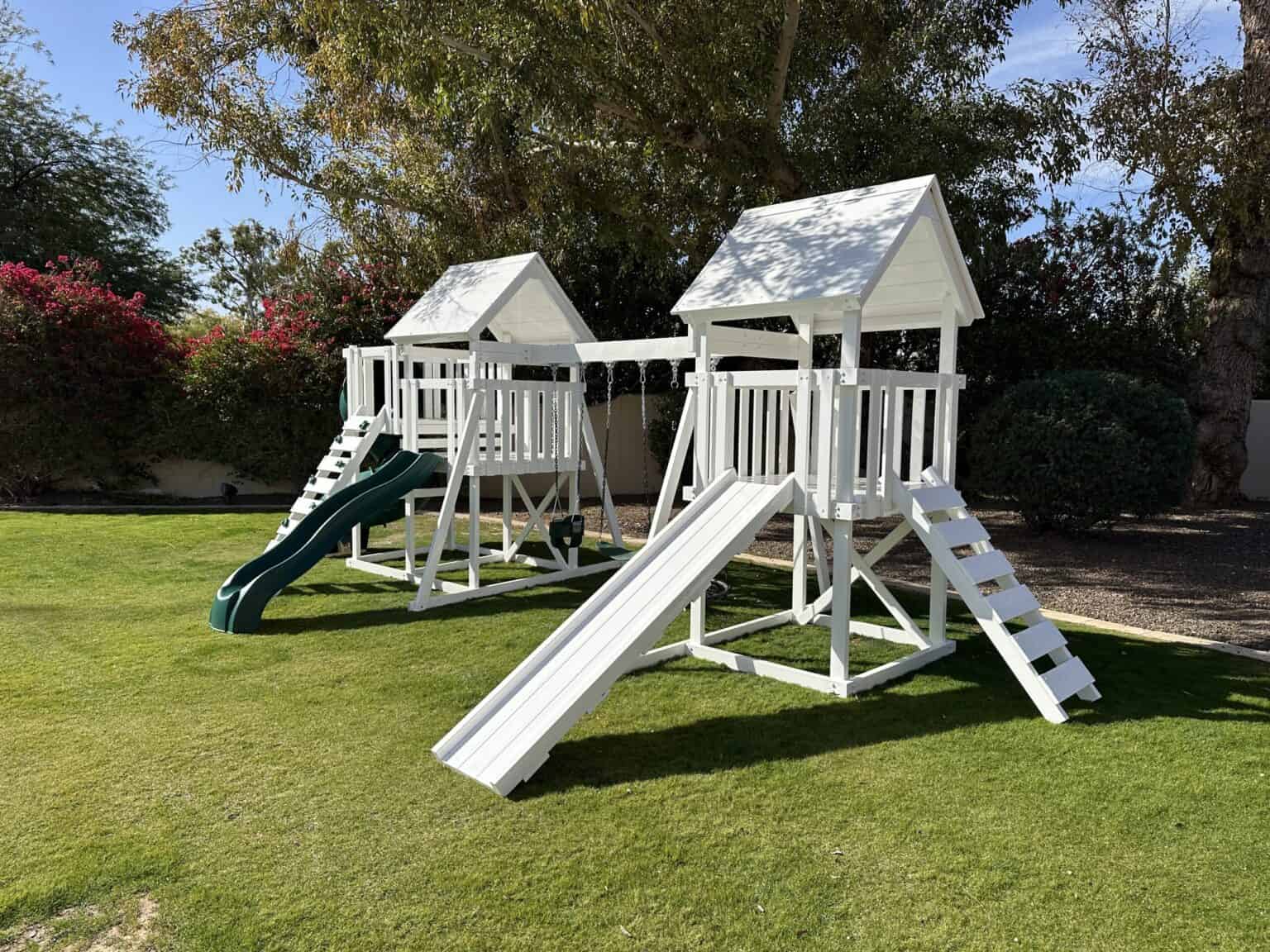 Watch Tower Vinyl playset in backyard with green grass and large tree.