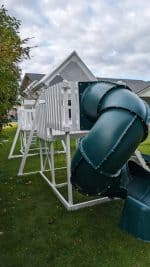 Watch Tower Vinyl playset in backyard with green grass and large tree.
