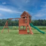 Wooden outdoor playset with slide and swings for kids in Texas backyard.