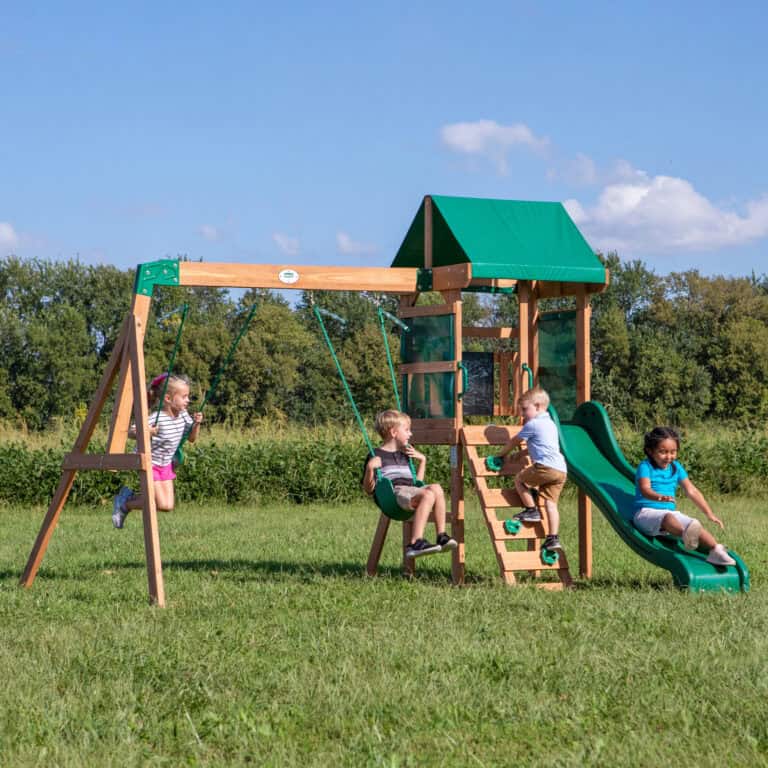 Children playing on a wooden outdoor playset with slide and swings in Texas.