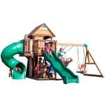 Children playing on Cedar Cove outdoor playset with slide and swings.